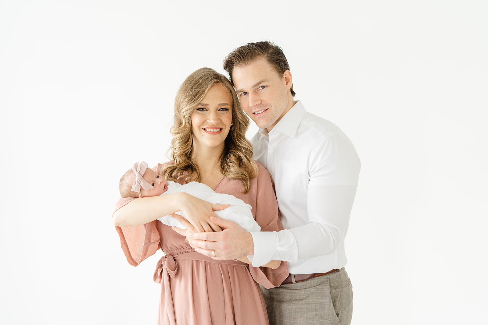 Mom and dad with newborn baby at Atlanta Newborn Photographer studio