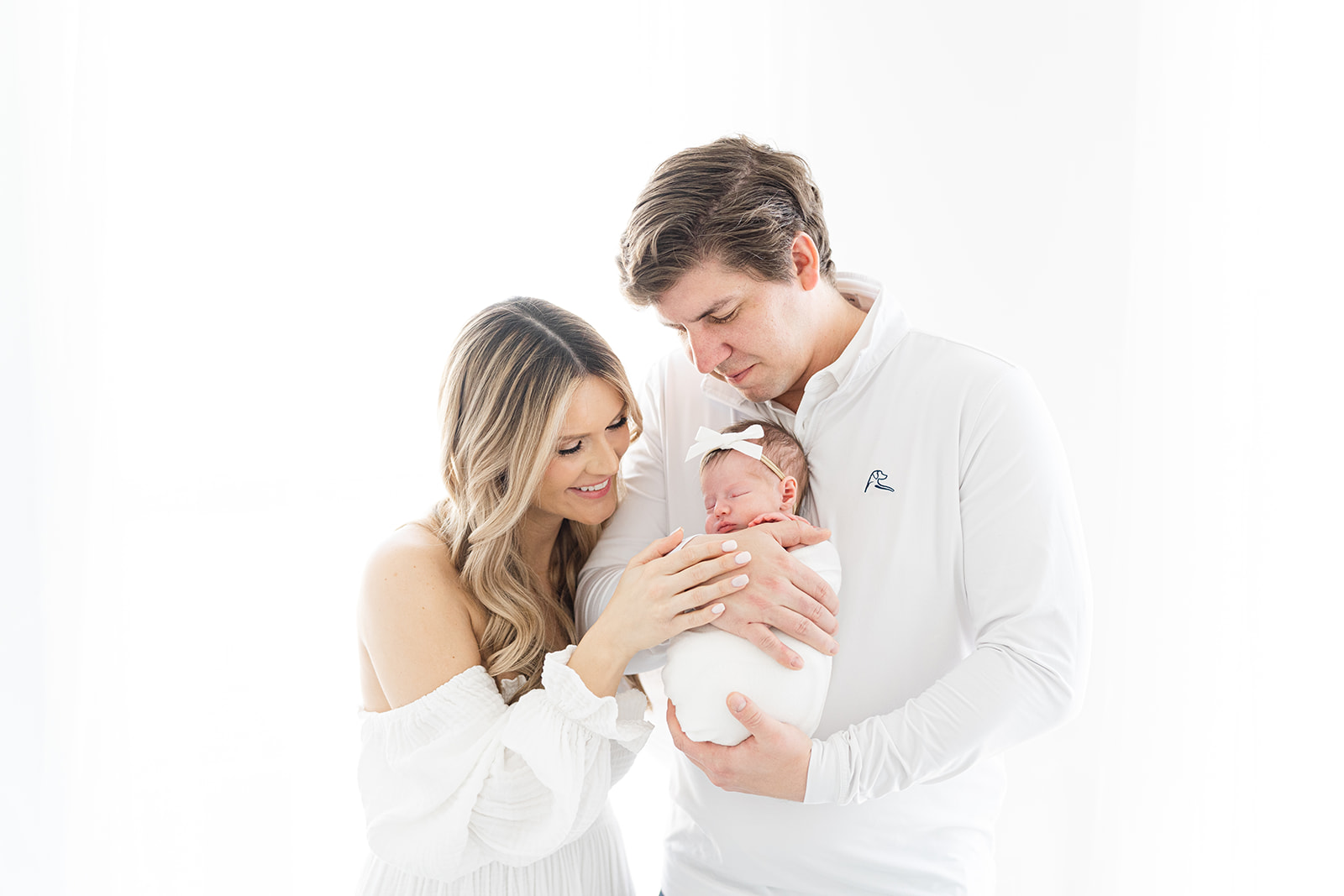 Mom and Dad looking at newborn baby during Atlanta Newborn Photographer session