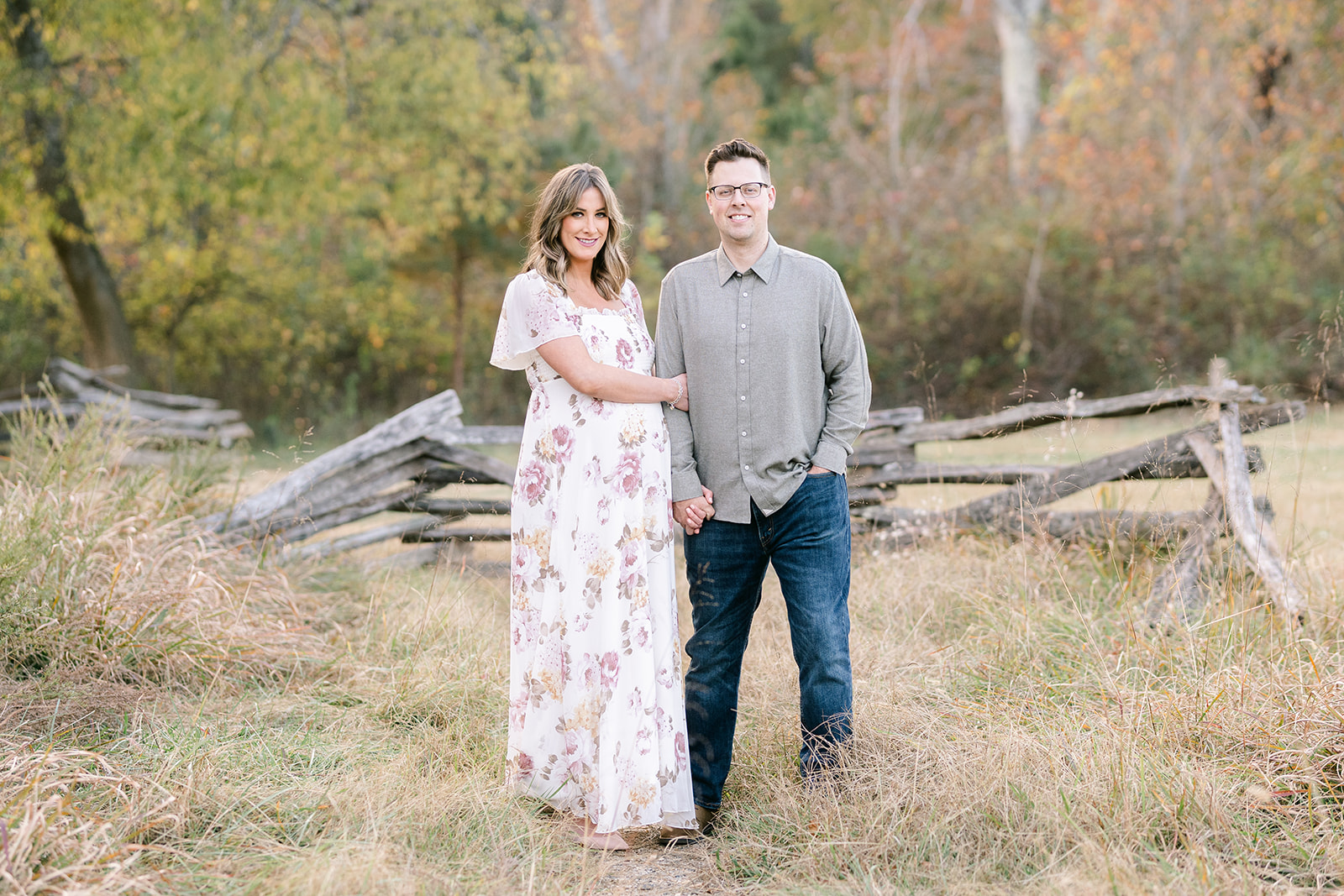 Couple in Marietta field for session with Lindsey Powell Photography Marietta Maternity Photographer