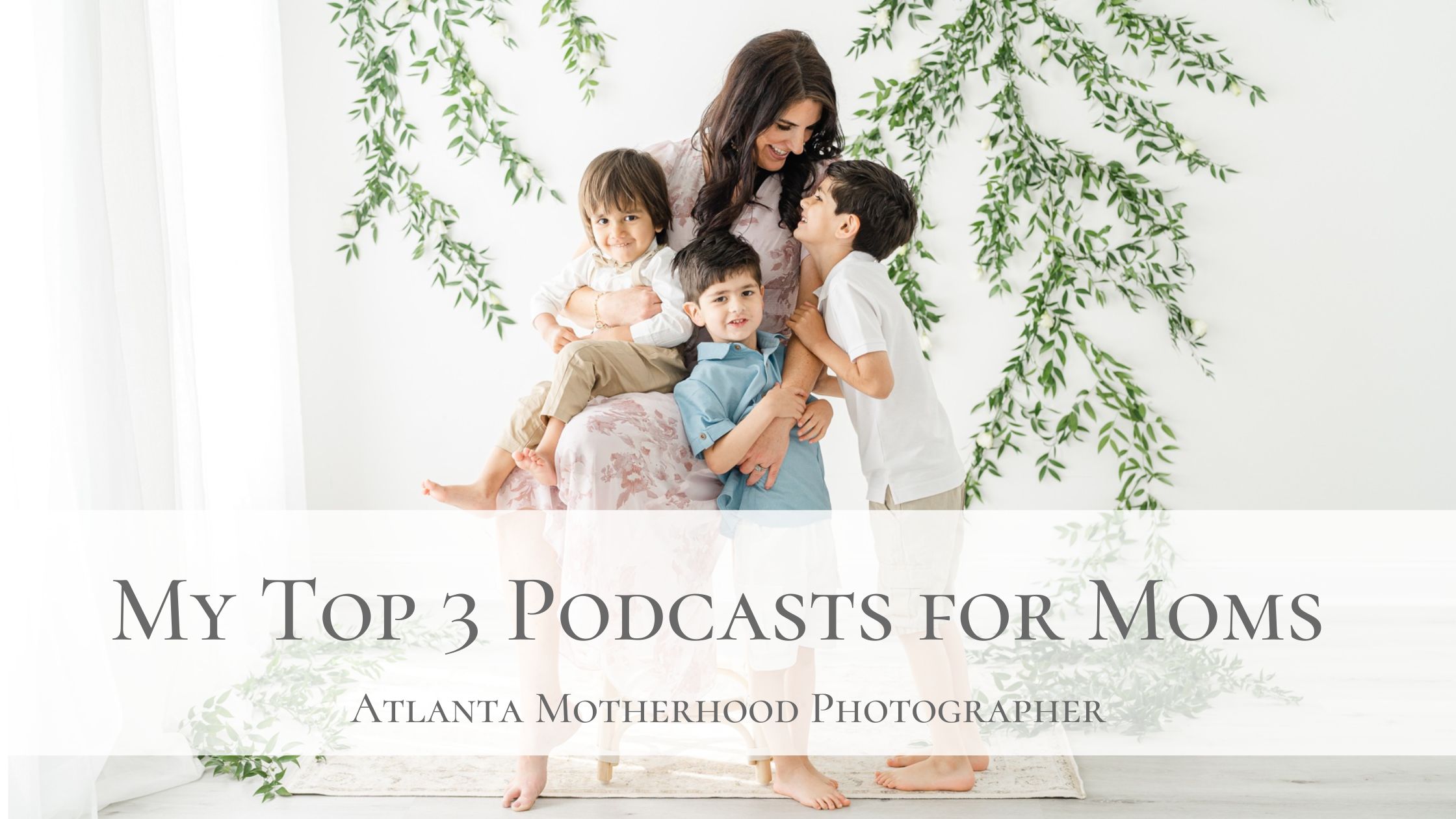 Portrait of a mother with her three sons smiling at each other.