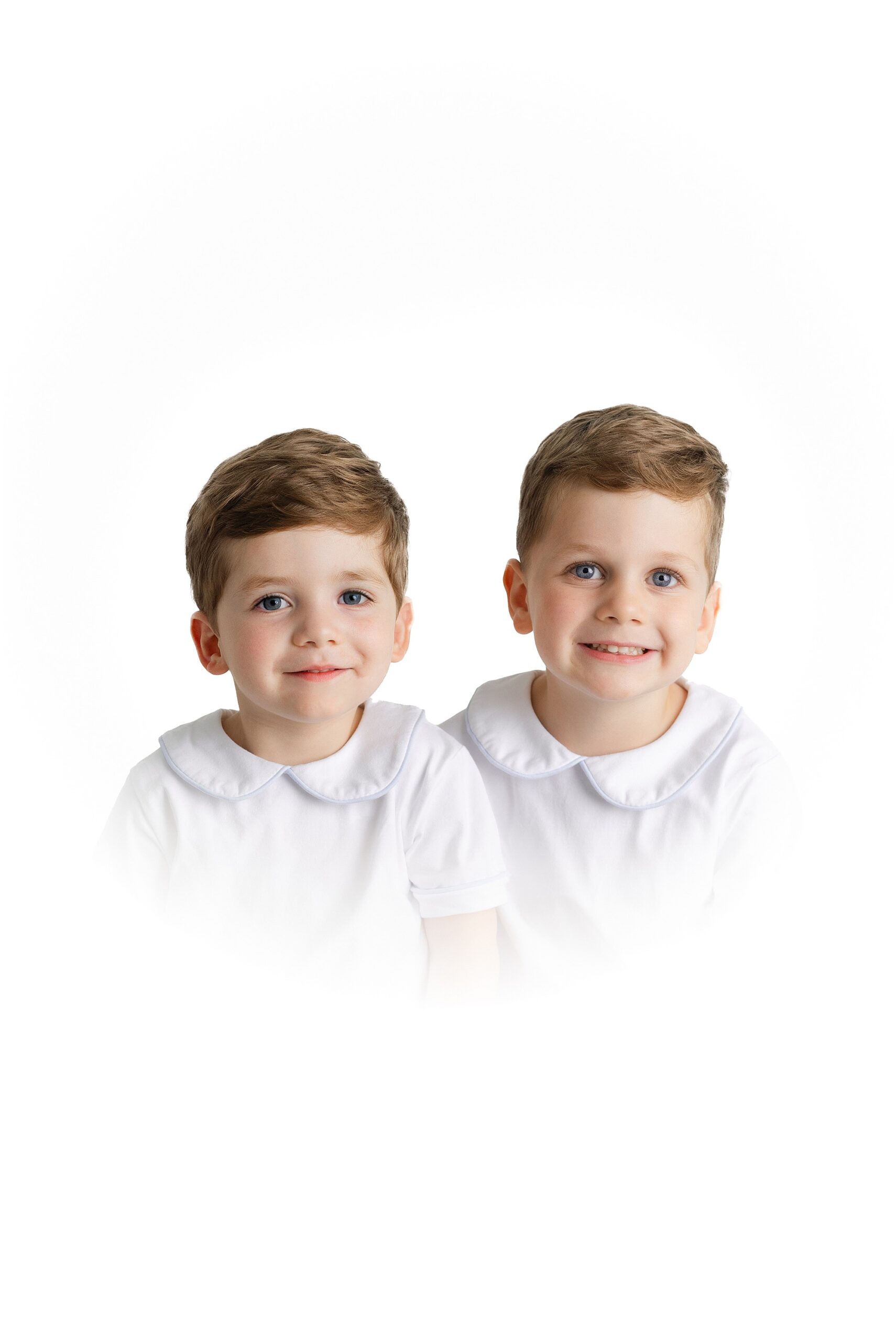 Heirloom portraits in Atlanta of two young boys with a white vignette.